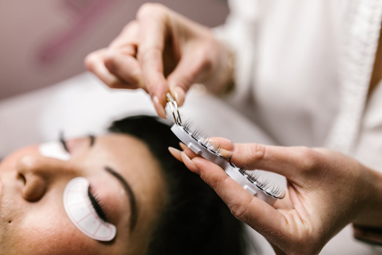 hero-img Detailed view of eyelash extension procedure in salon setting.